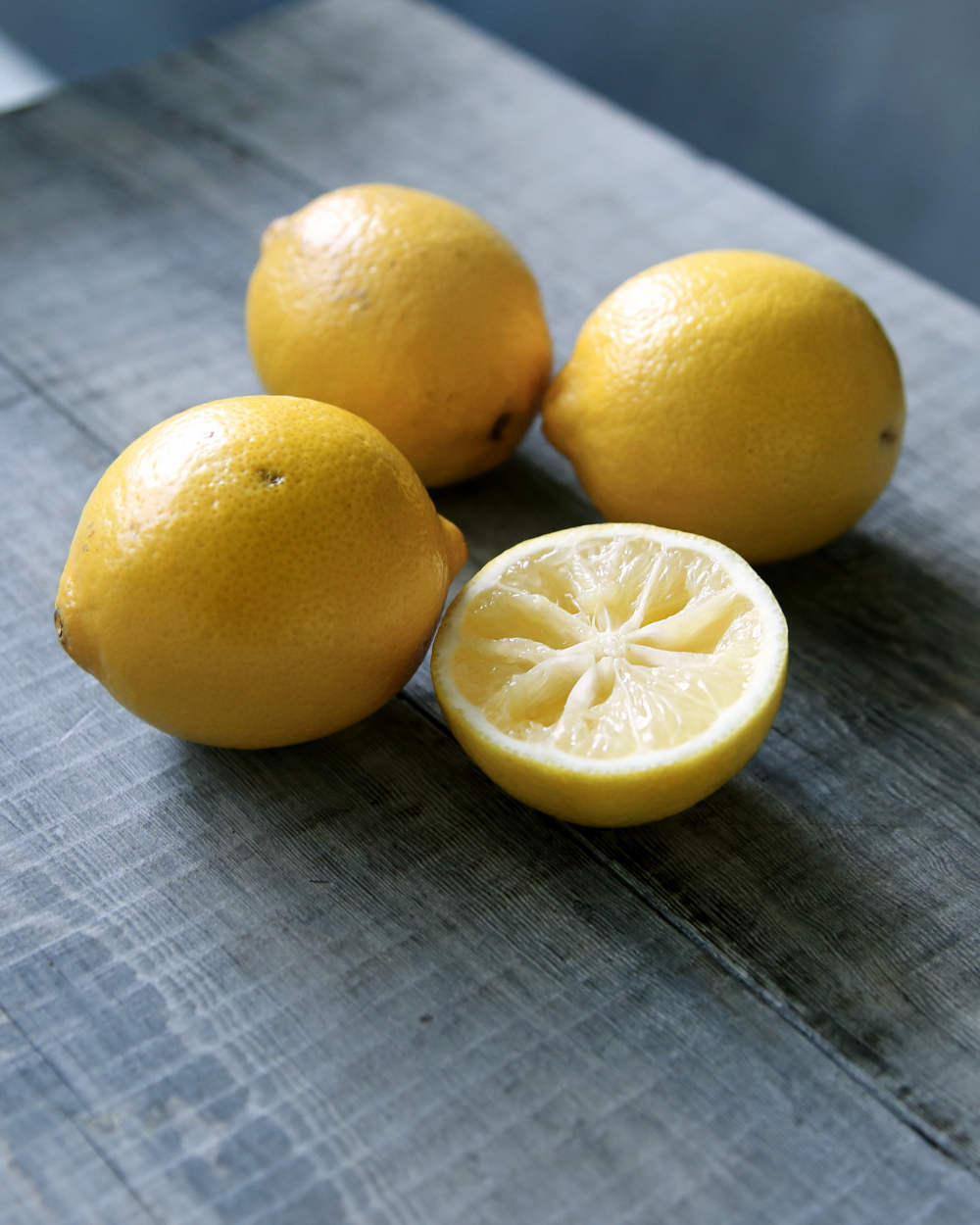 Three yellow lemon beside sliced lemon | How To Grow A Lemon Tree From Seed | can you grow a lemon tree from a seed