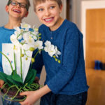 Little boys carrying a flower for their mother | Sweet Mothers Day Plants And Flowers To Gift For Moms | mother's day plants | featured