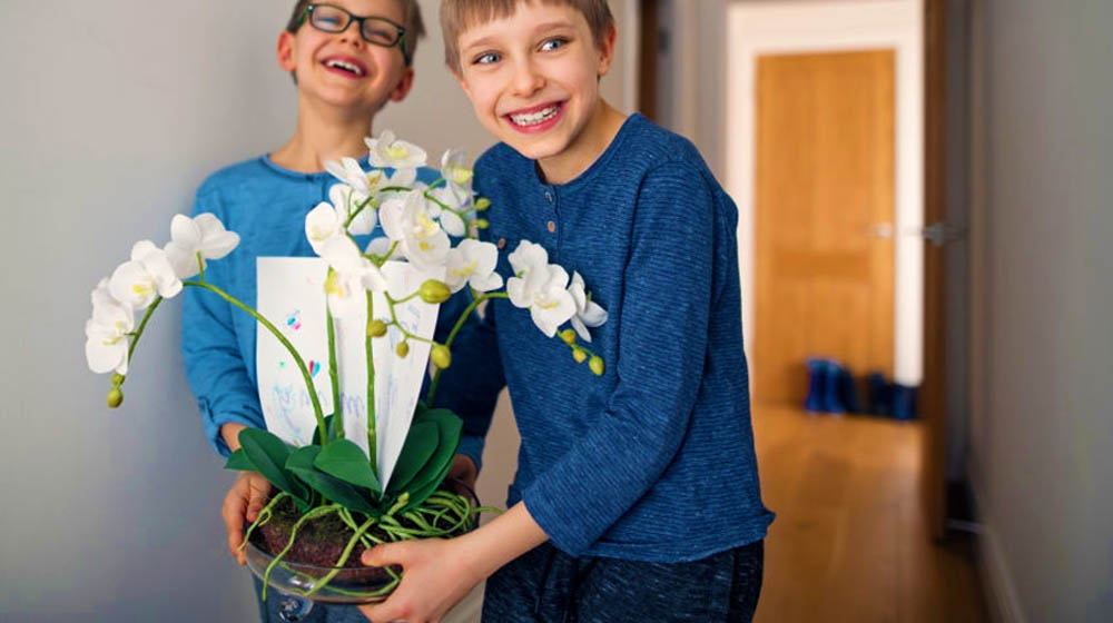 Little boys carrying a flower for their mother | Sweet Mothers Day Plants And Flowers To Gift For Moms | mother's day plants | featured