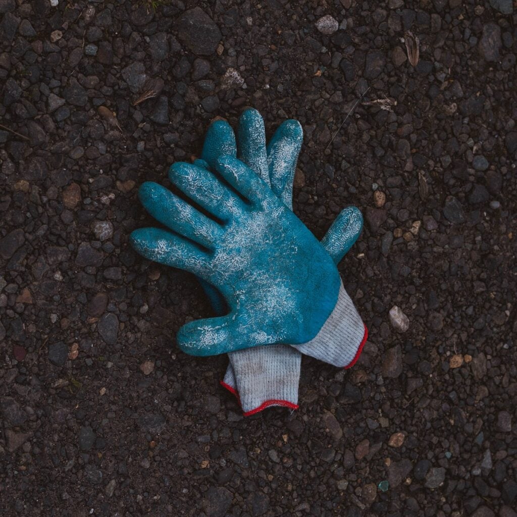Garden Gloves blue and gray gloves on black soil