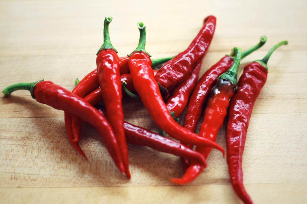 Pile of red chili | The Best Homemade Dog Repellent For Your Garden | essential oils