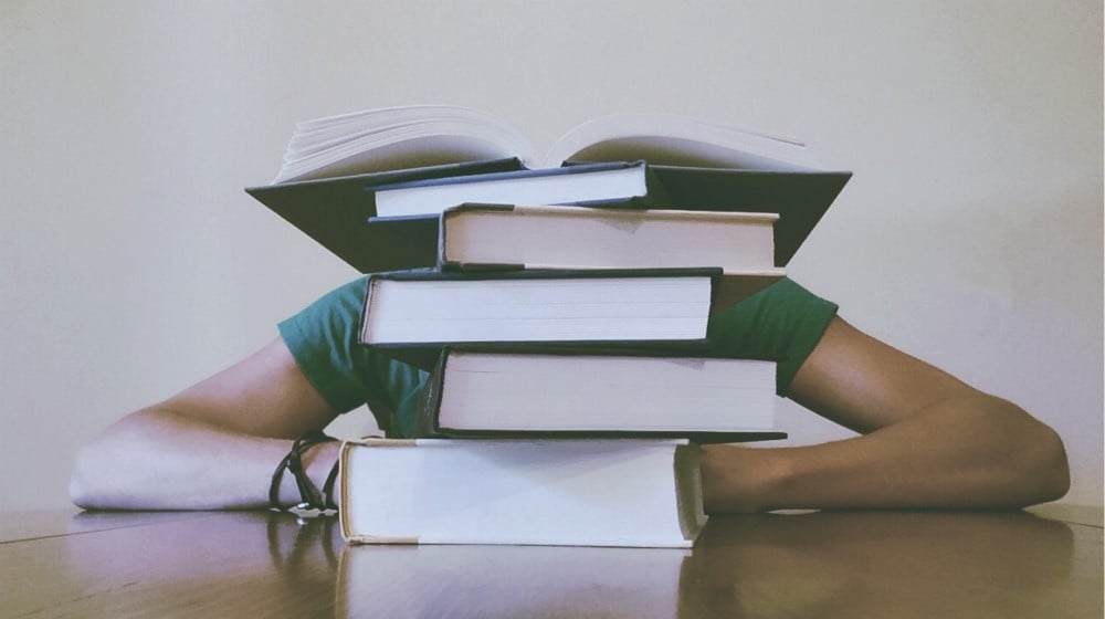 adult behind books | Small Garden Ideas And Tips | How To Design Gardens In Limited Spaces | small garden ideas | small garden